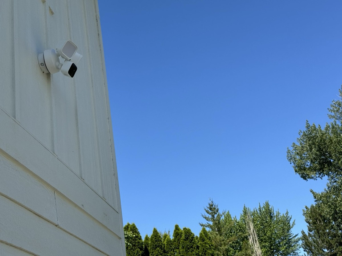 A security camera mounted on the outside wall of the house